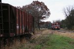 Ballast hoppers sit in storage on one of the legs of the wye as L593 passes